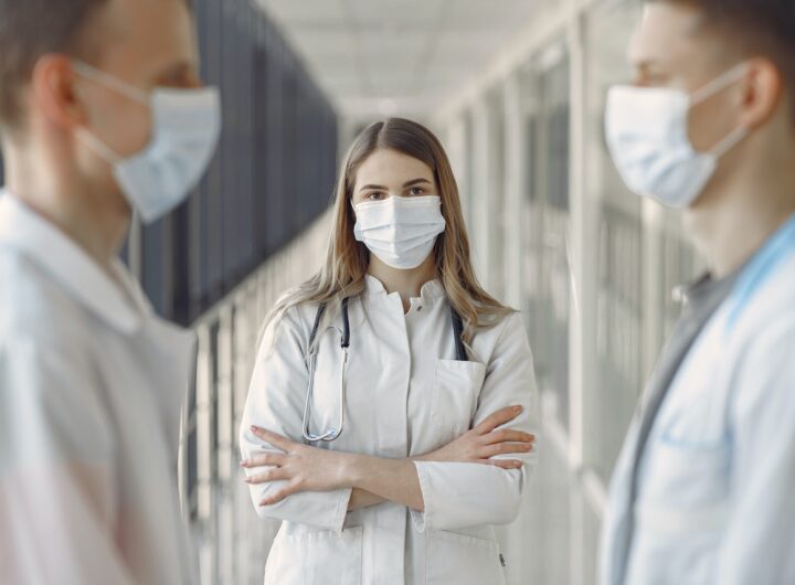 Diverse group of medical professionals in discussion at a hospital.